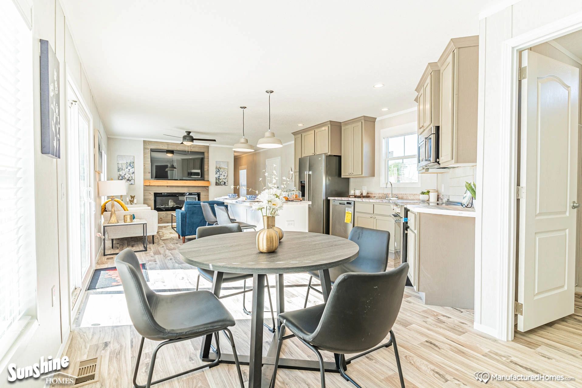 There is a dining table and chairs in the middle of the room.