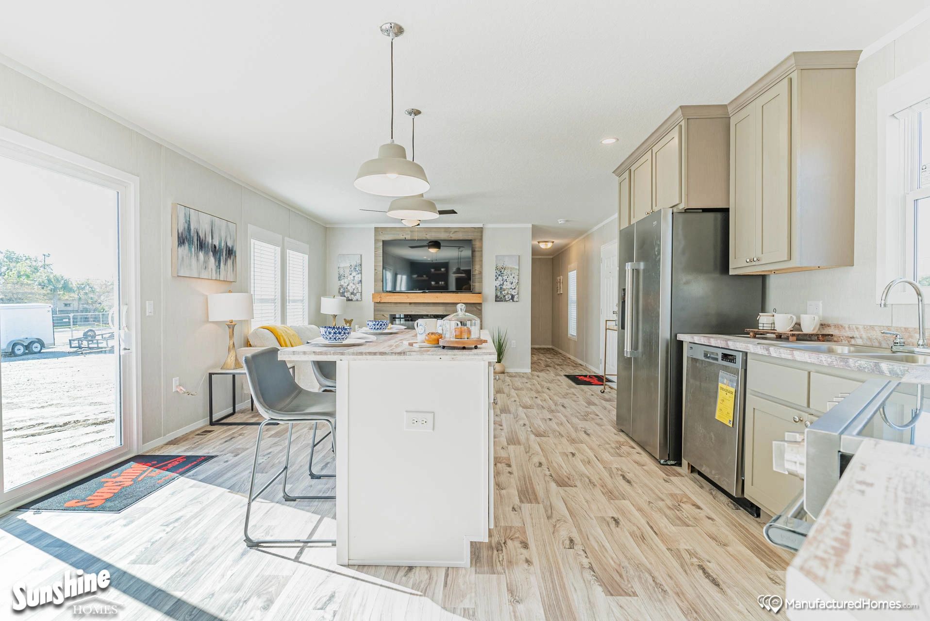 A kitchen with stainless steel appliances and a large island in the middle of the room.
