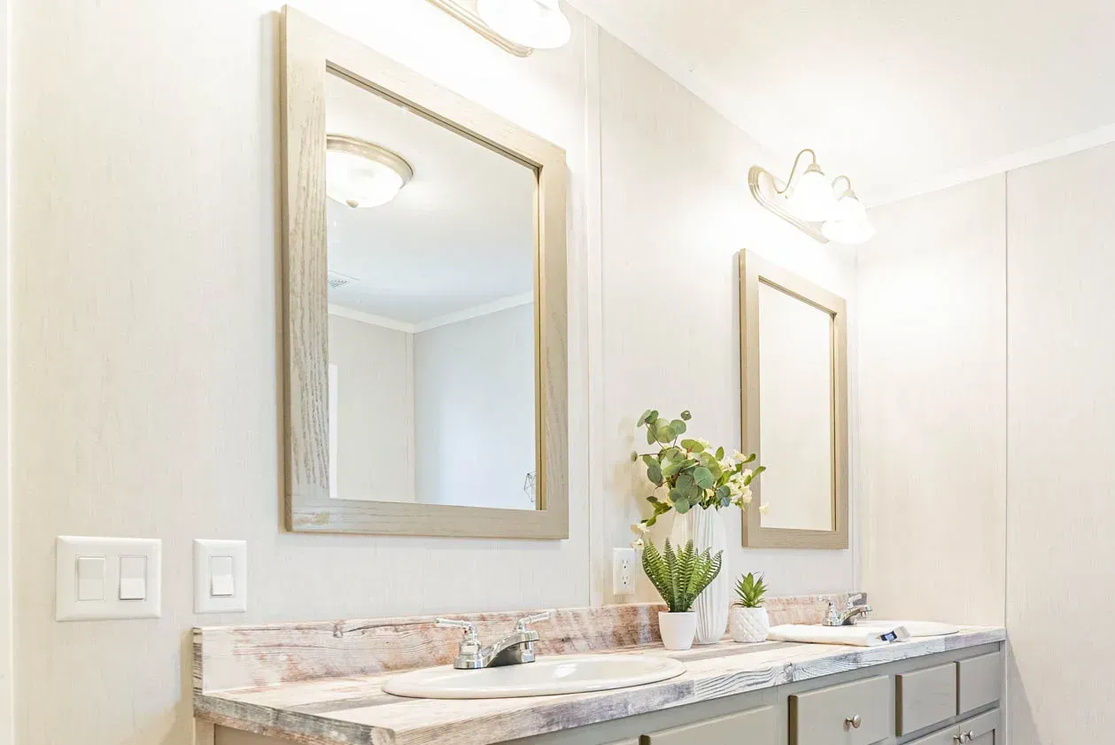A bathroom with two sinks and two mirrors.
