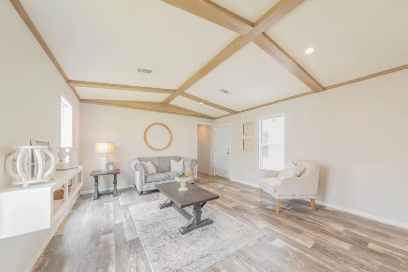 A living room with a couch , chair and coffee table.