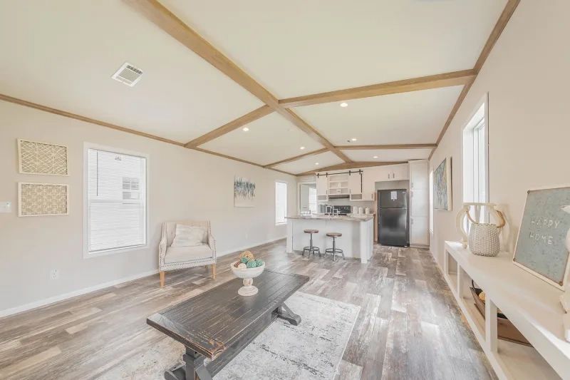 A living room in a mobile home with a coffee table and chairs.
