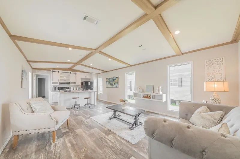 A living room with a couch , chairs , and a coffee table.