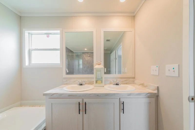 A bathroom with two sinks and two mirrors.