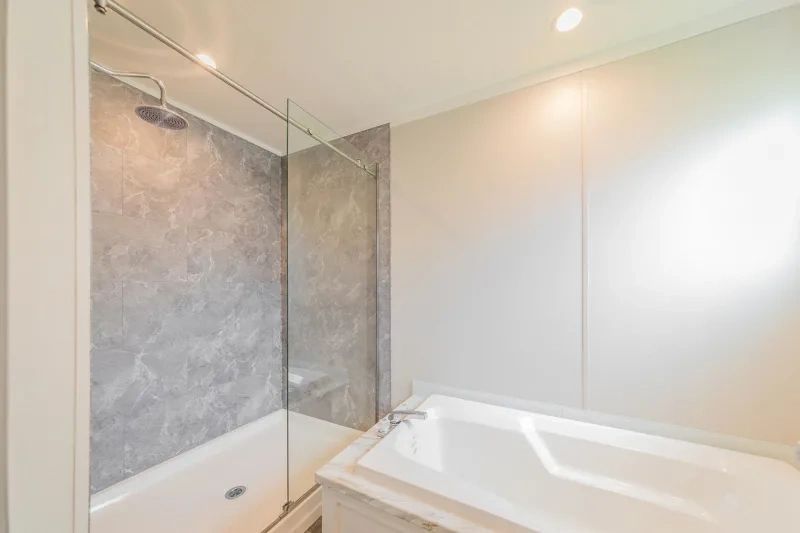 A bathroom with a bathtub and a walk in shower.