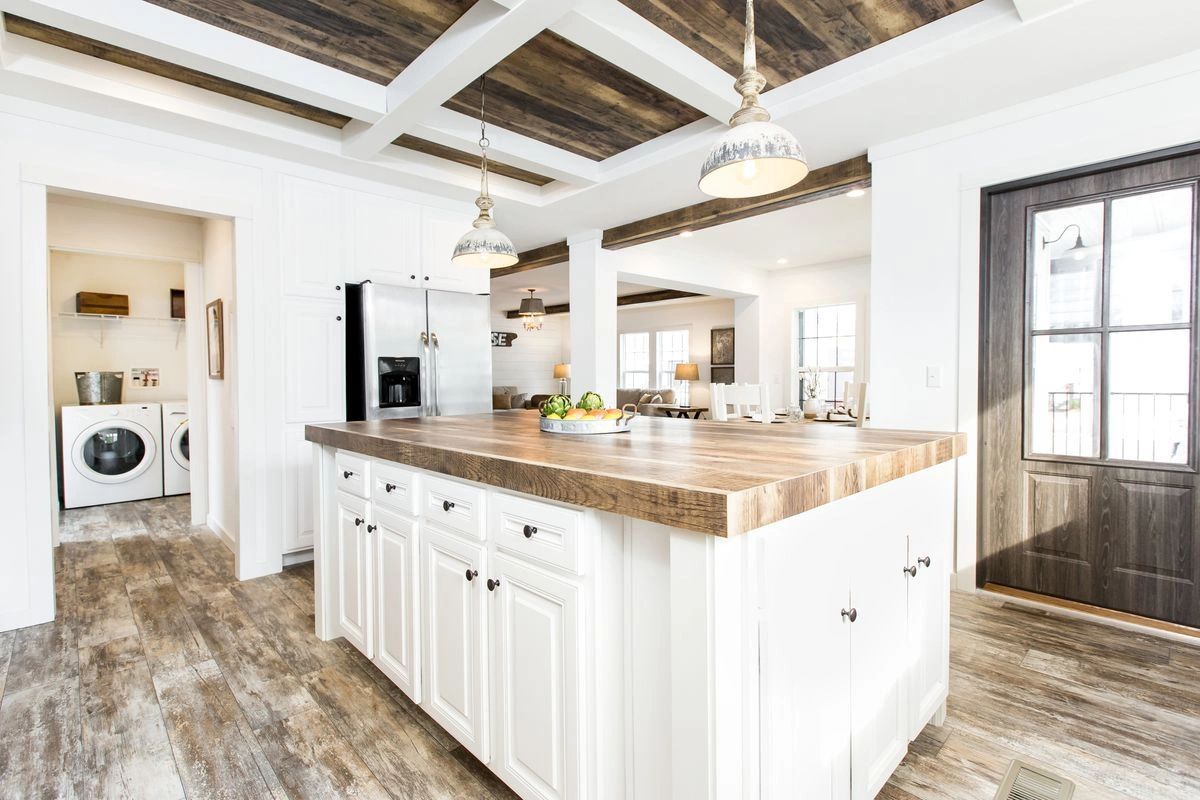 A kitchen with a large island in the middle of it.