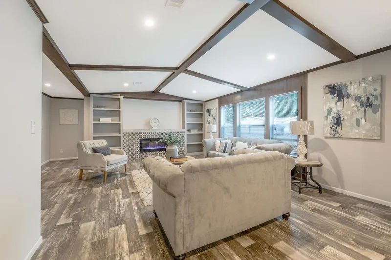 A living room with a couch , chairs , and a fireplace.