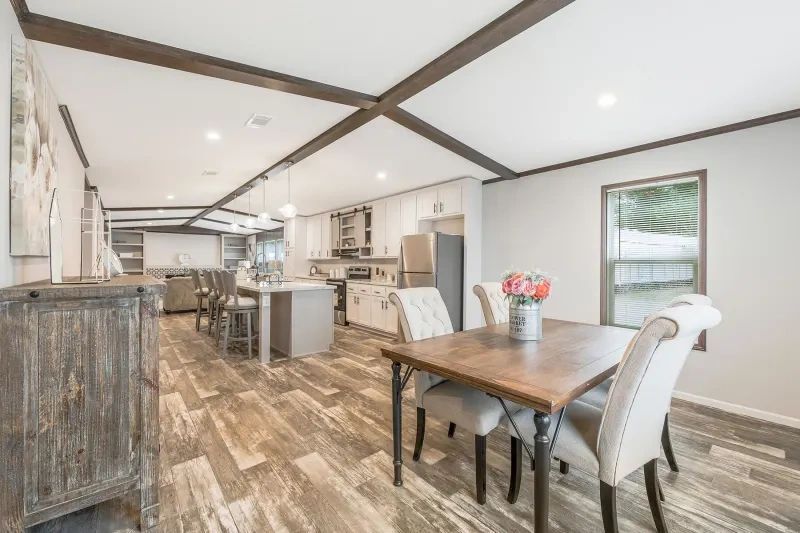 There is a dining table and chairs in the middle of the room.