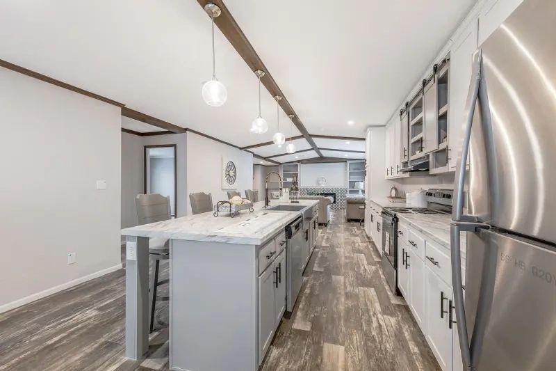 A kitchen with stainless steel appliances and a large island.