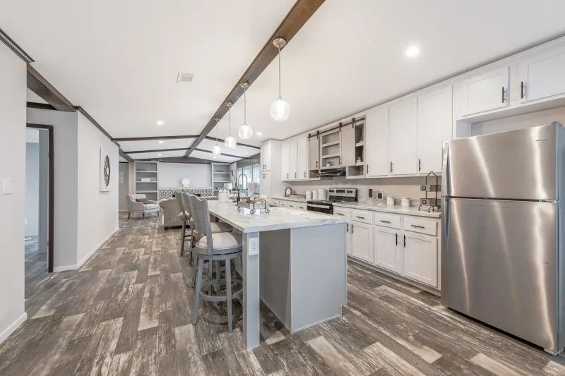 A kitchen with stainless steel appliances and a large island.