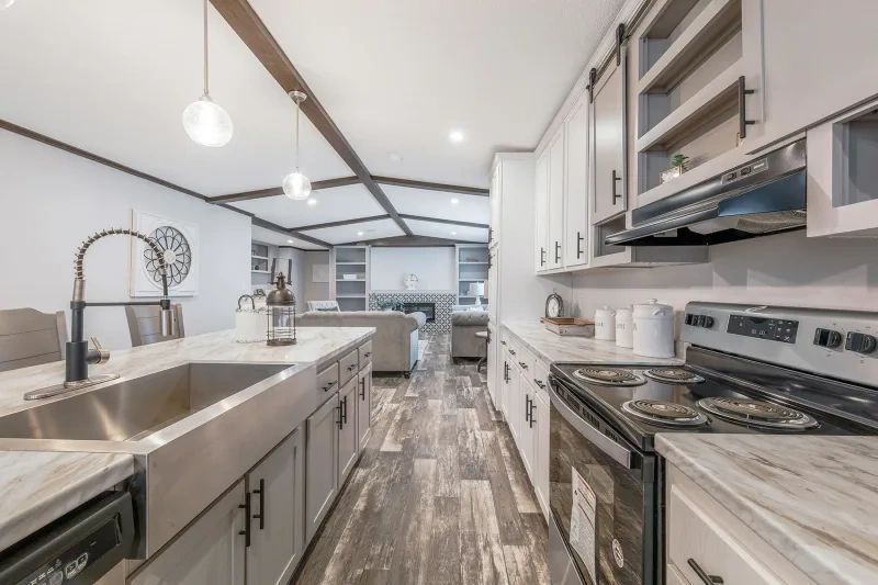A kitchen with a stove , sink , and dishwasher.