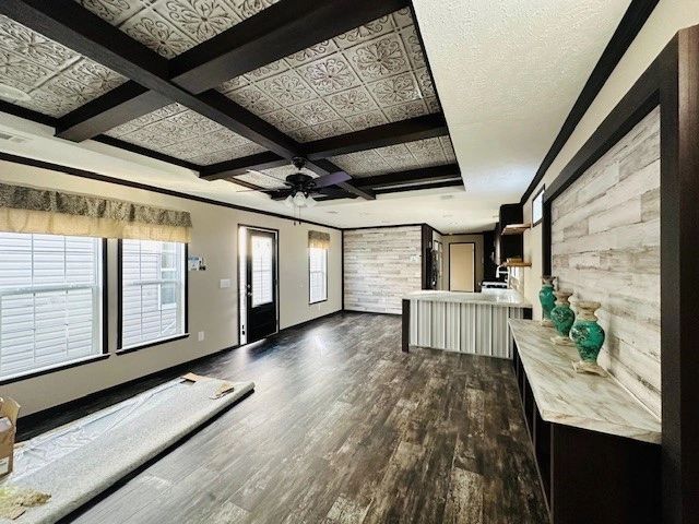 A living room with hardwood floors and a ceiling fan.