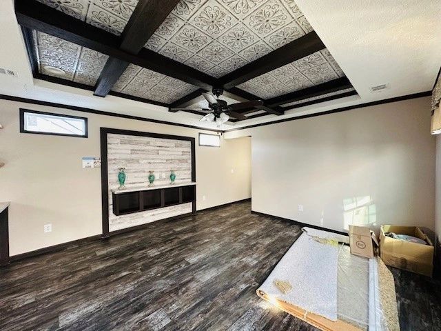 A living room with hardwood floors and a ceiling fan.