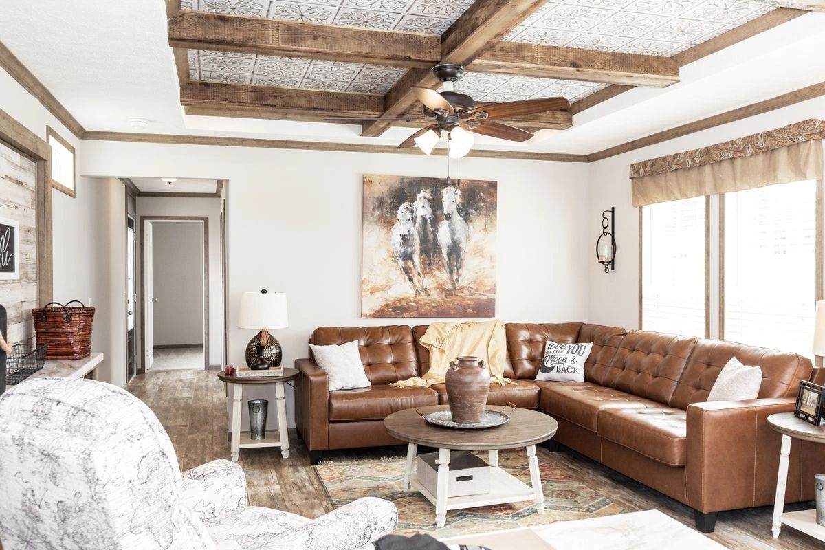 A living room filled with furniture and a ceiling fan.