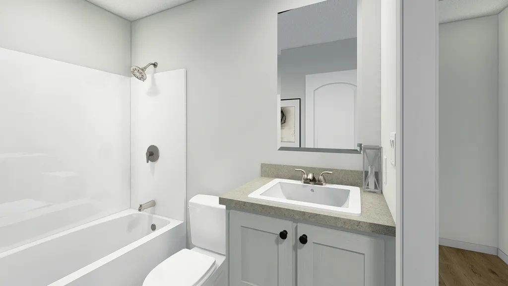 A bathroom with a sink , toilet , bathtub and mirror.