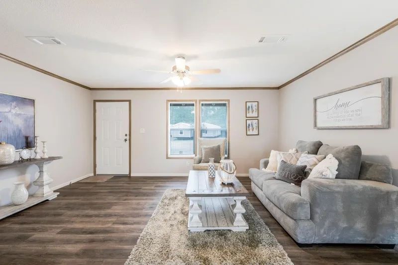 A living room with a couch , coffee table , and rug.