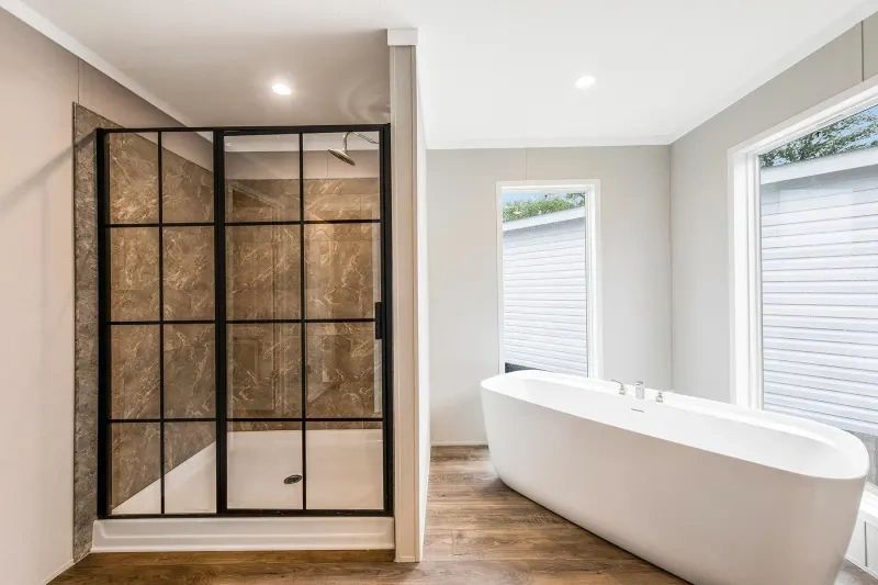 A bathroom with a walk in shower and a bathtub.