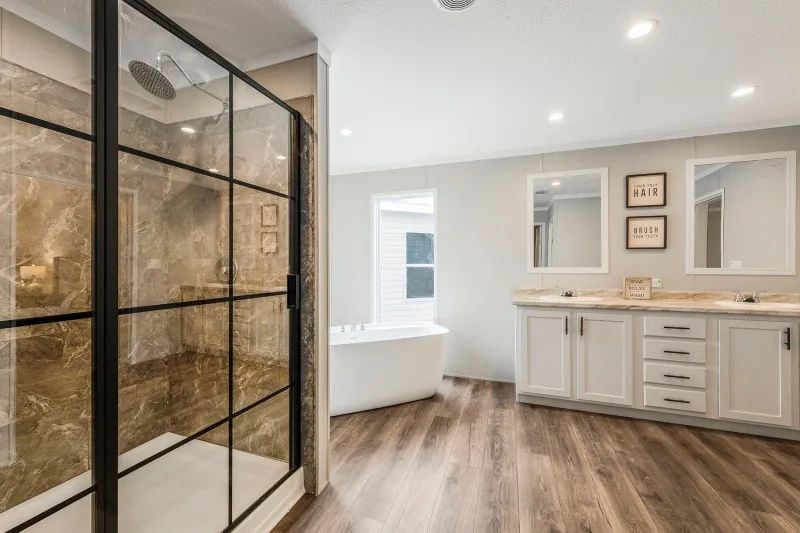 A bathroom with a walk in shower and two sinks.