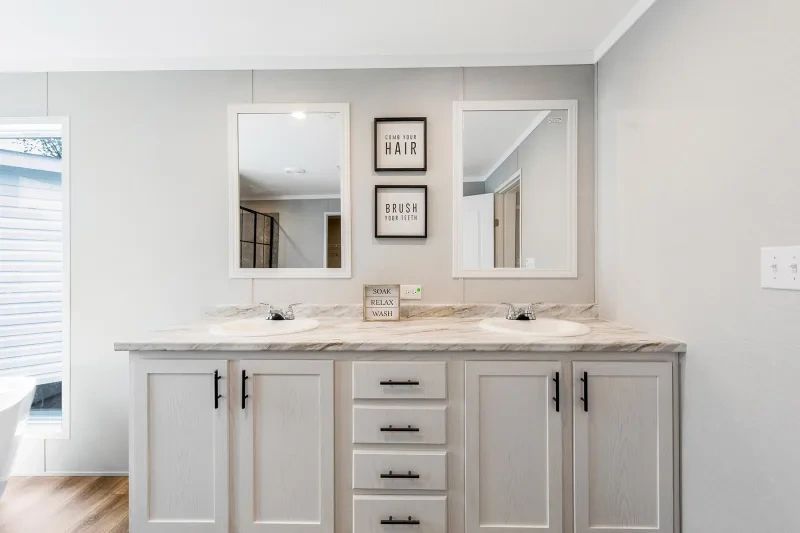 A bathroom with two sinks and two mirrors.