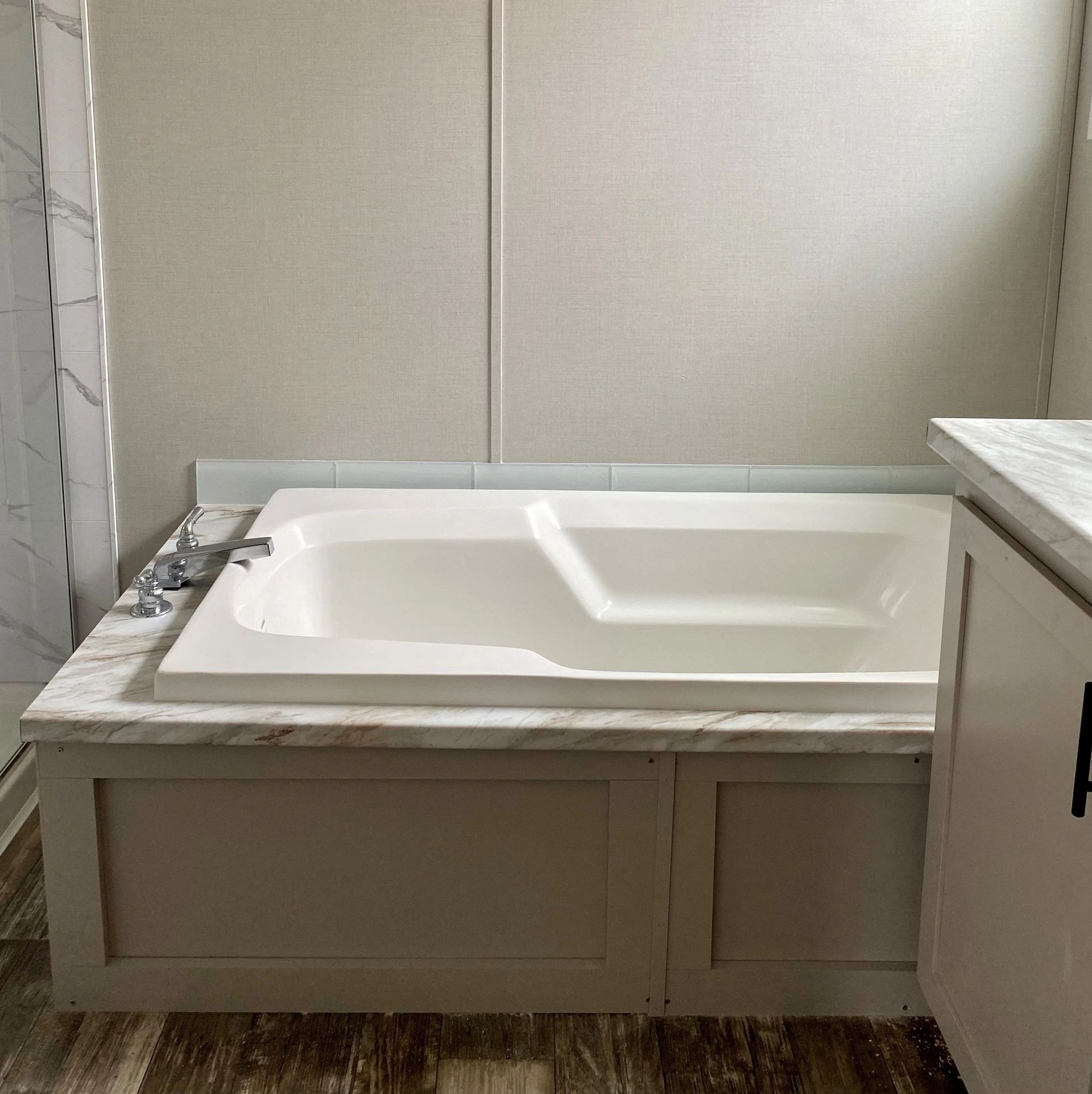 There is a bathtub in the middle of the bathroom.