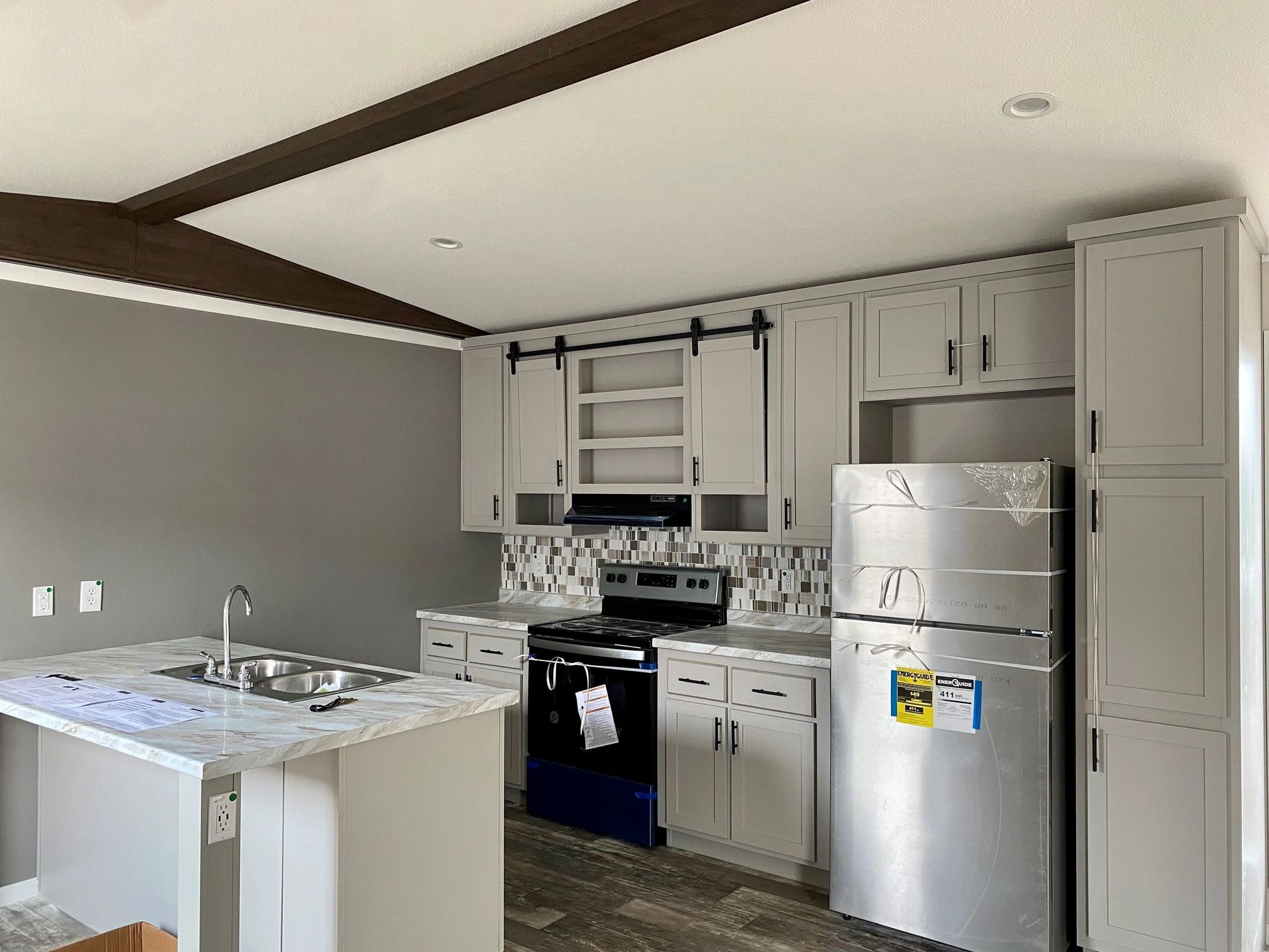 A kitchen with stainless steel appliances and white cabinets.