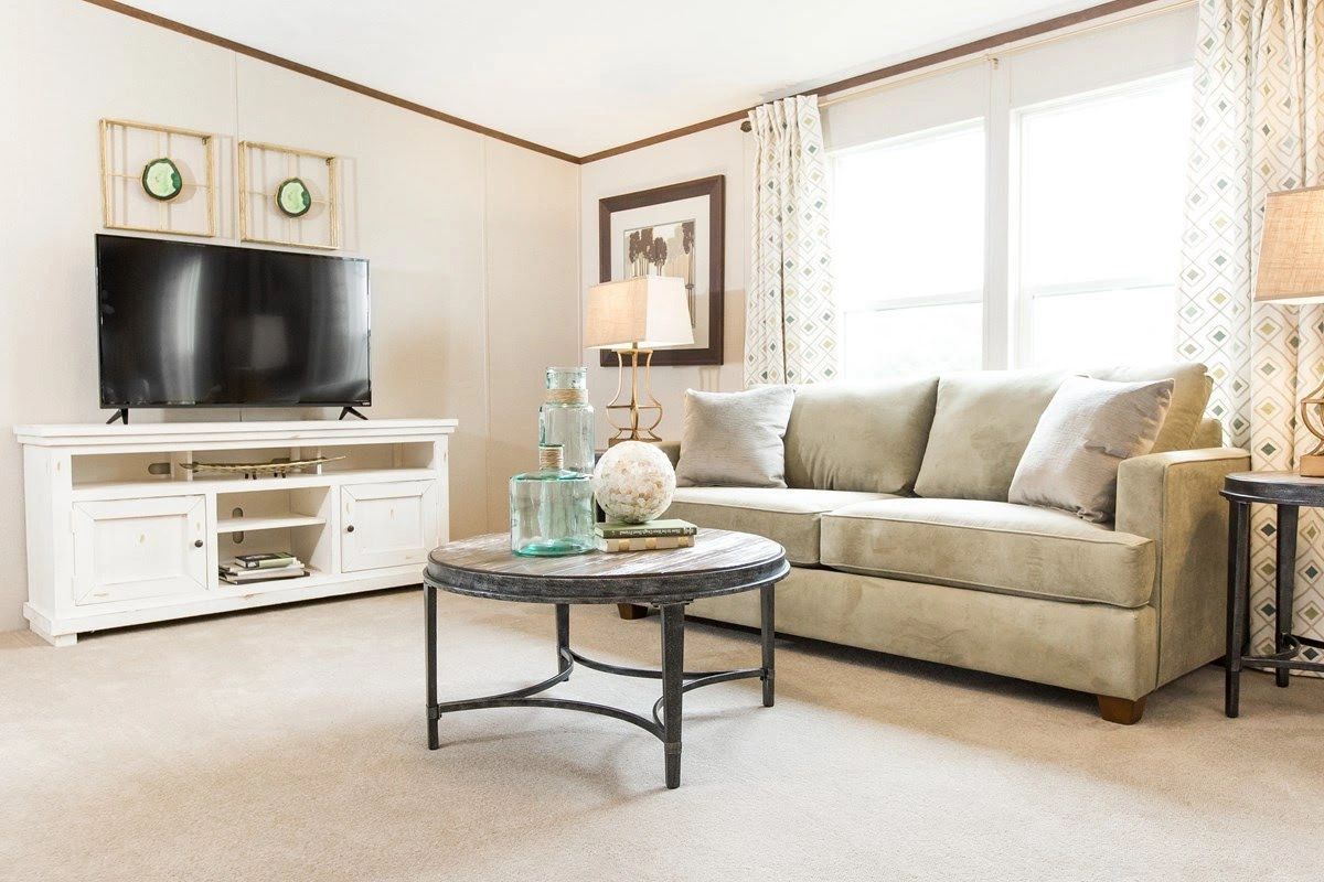 A living room with a couch , coffee table , and television.