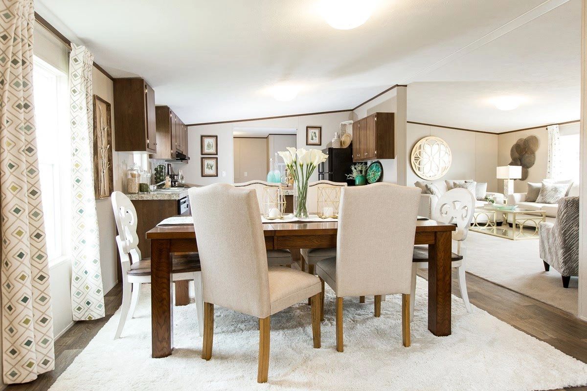 A dining room with a table and chairs in it
