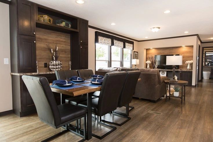 There is a dining table and chairs in the middle of the room.