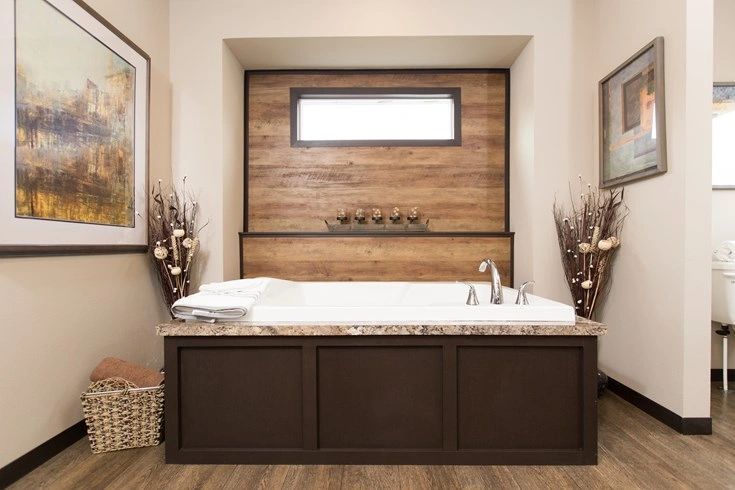 There is a large bathtub in the middle of the bathroom.