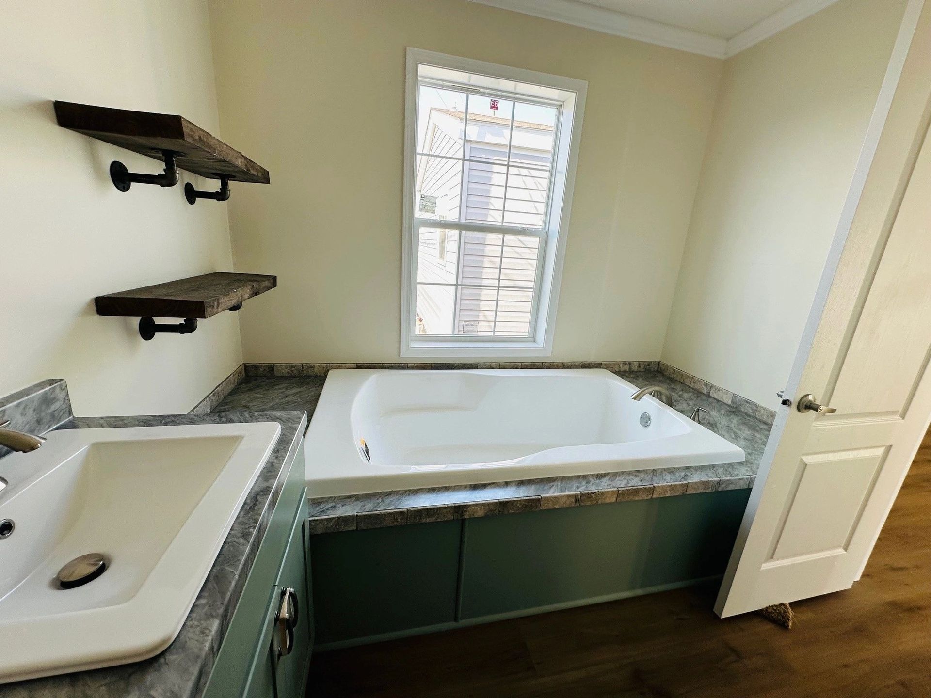 A bathroom with a jacuzzi tub and a sink