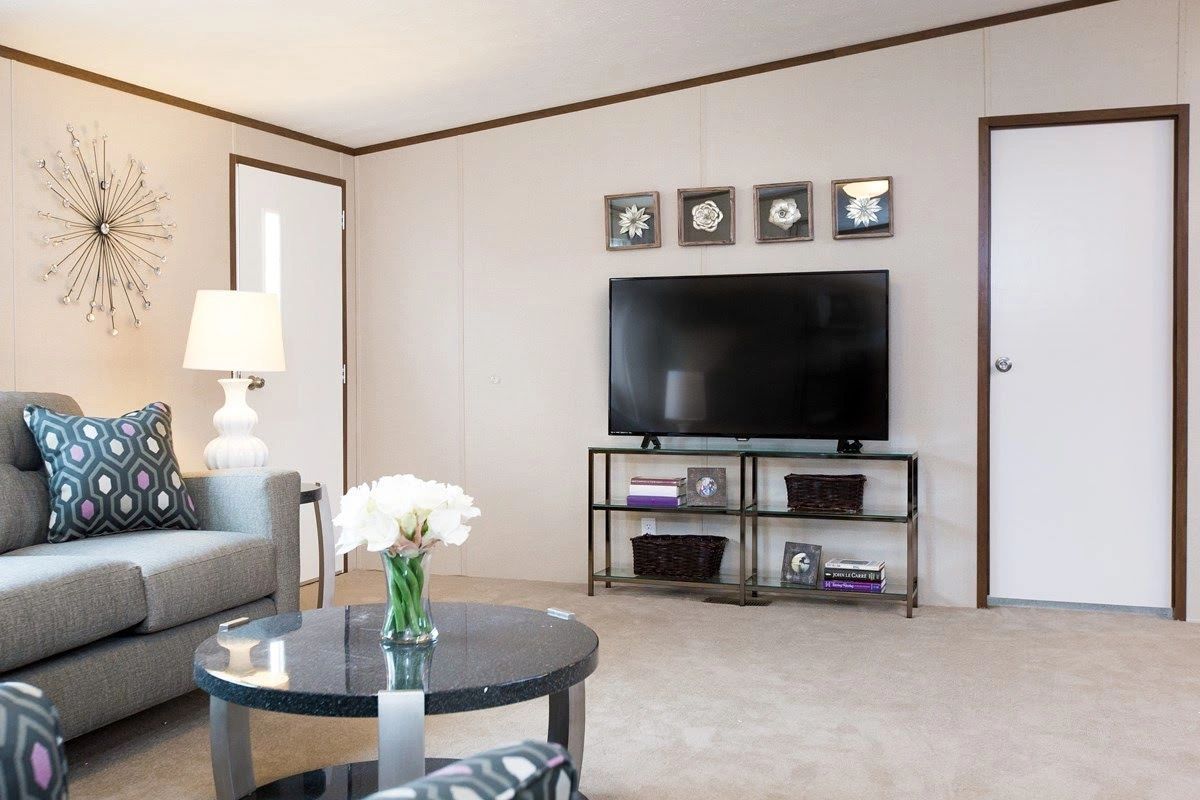 A living room with a couch , table , and television.