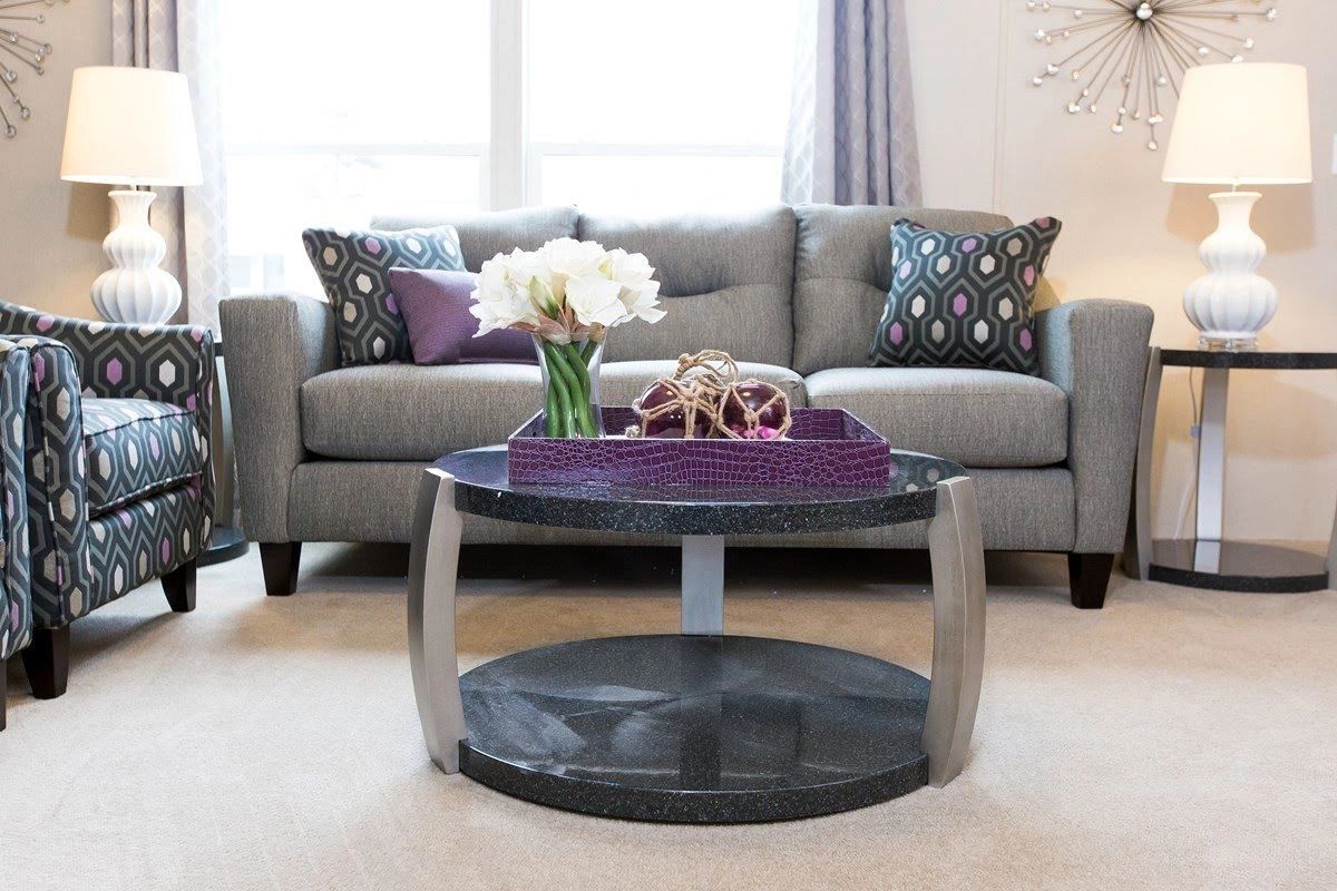 A living room with a couch a chair and a coffee table