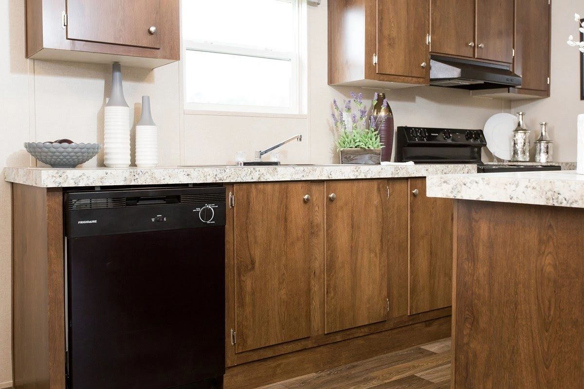 A kitchen with wooden cabinets and a black dishwasher.
