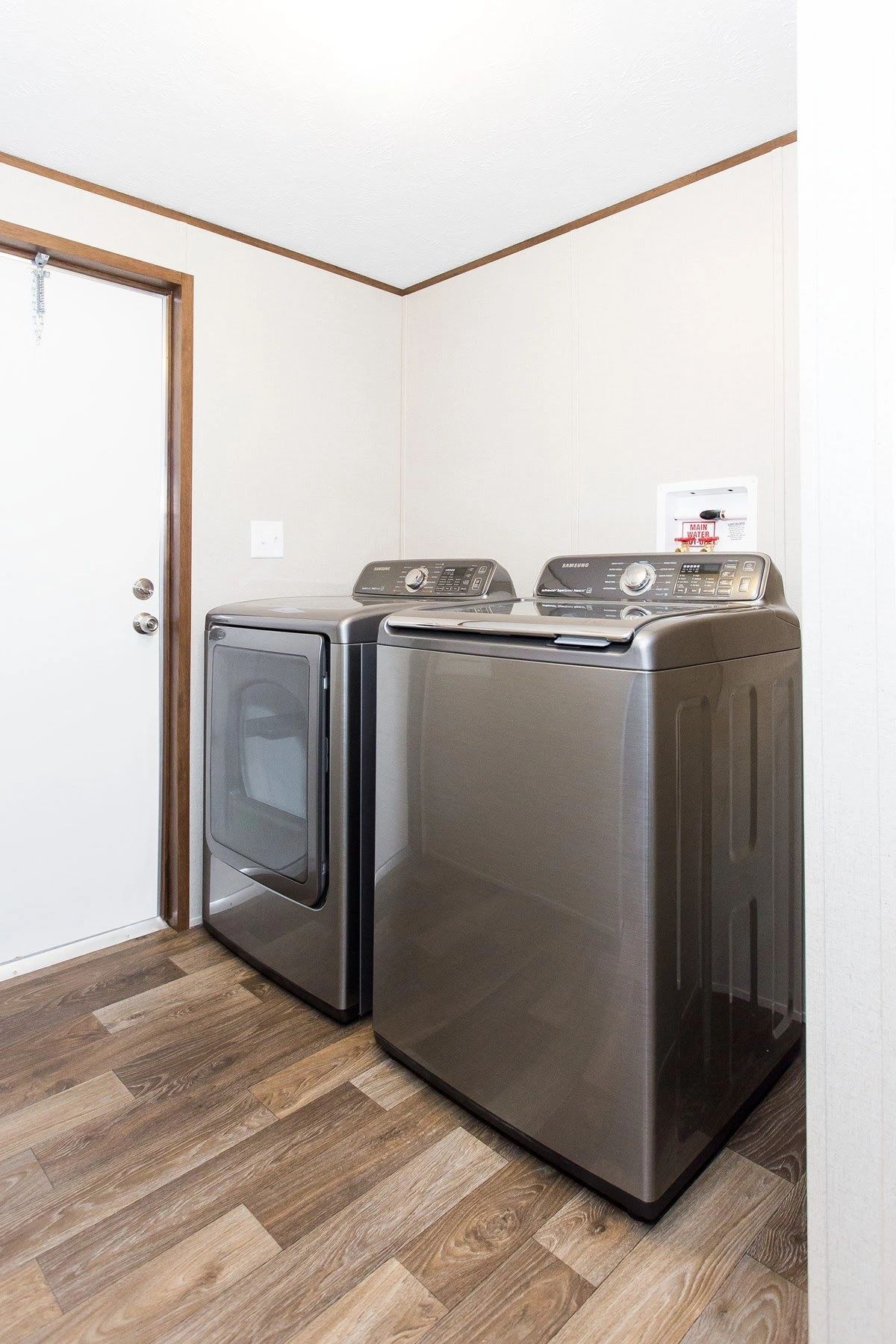 A laundry room with a washer and dryer in it.