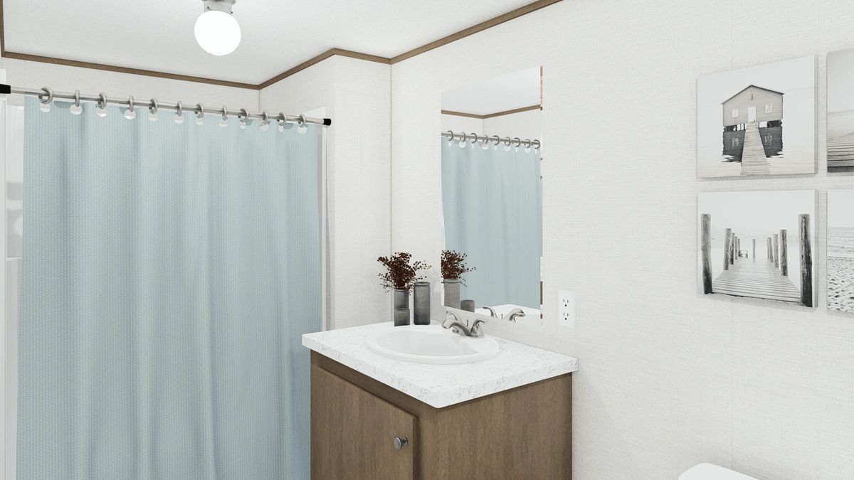 A bathroom with a sink , toilet , mirror and shower curtain.