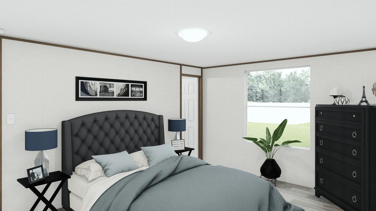 A bedroom with a bed , dresser , nightstands and a window.