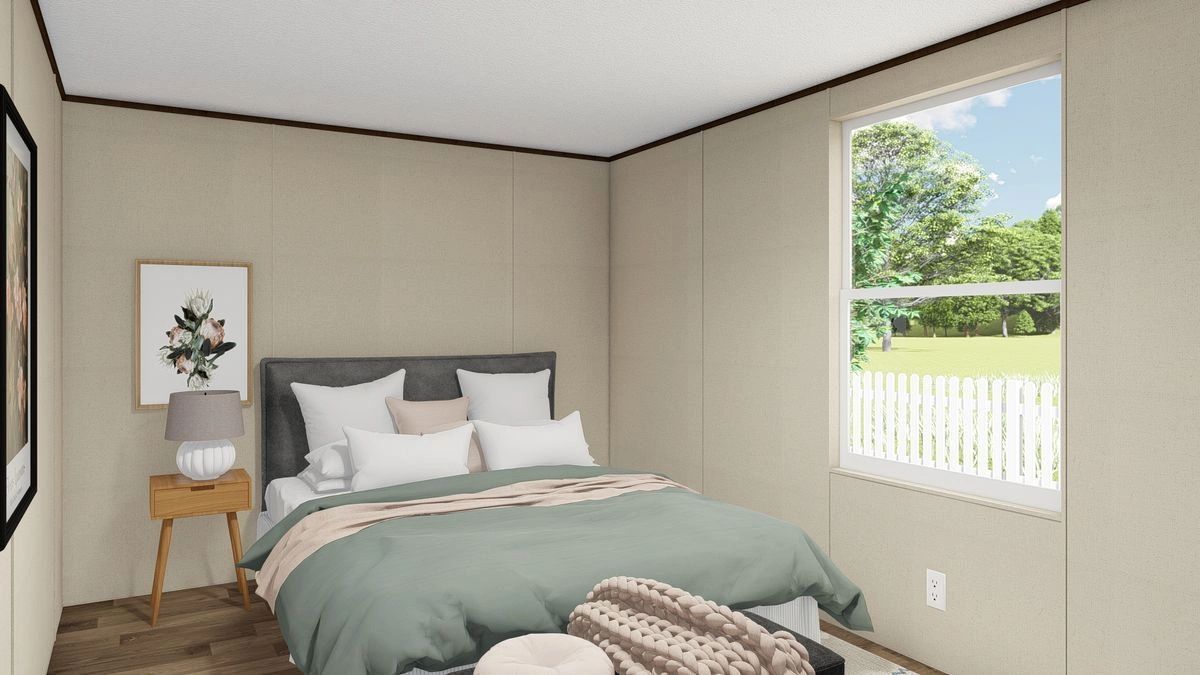 A bedroom with a large bed and a window.