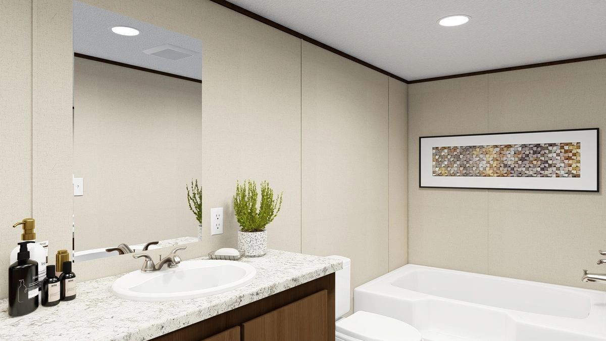 A bathroom with a sink , toilet , tub and mirror.