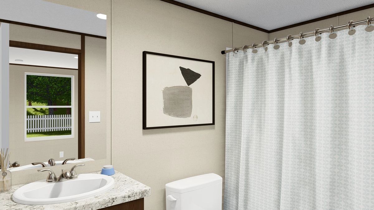 A bathroom with a sink , toilet , shower curtain and mirror.