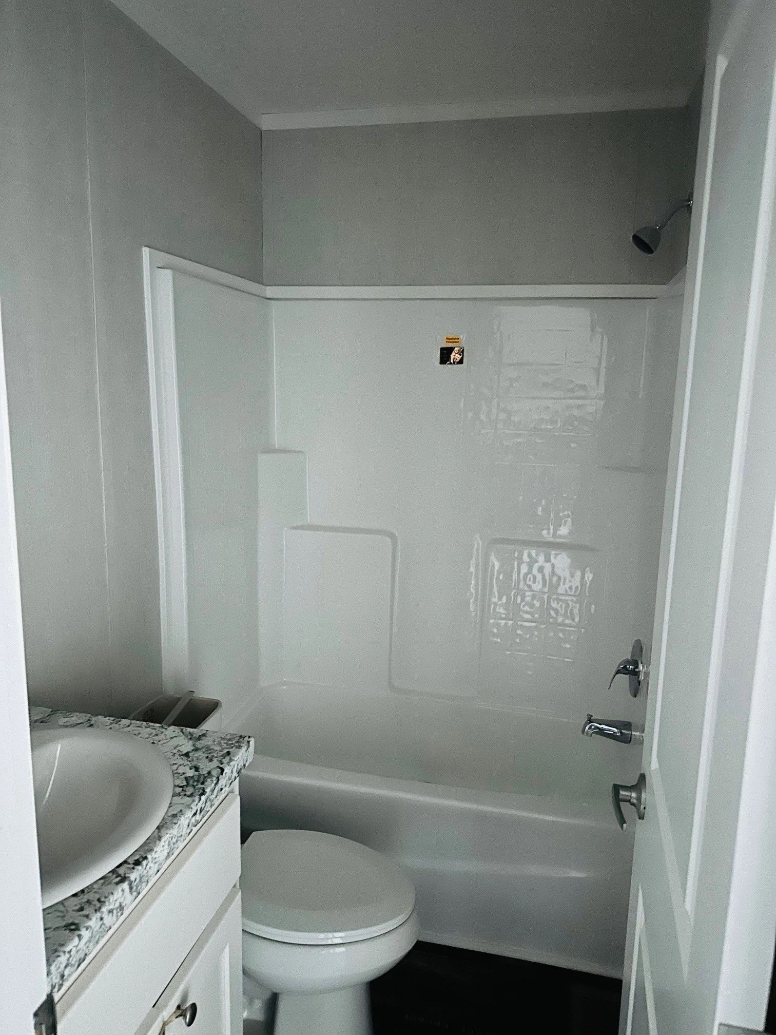 A bathroom with a toilet , sink and bathtub