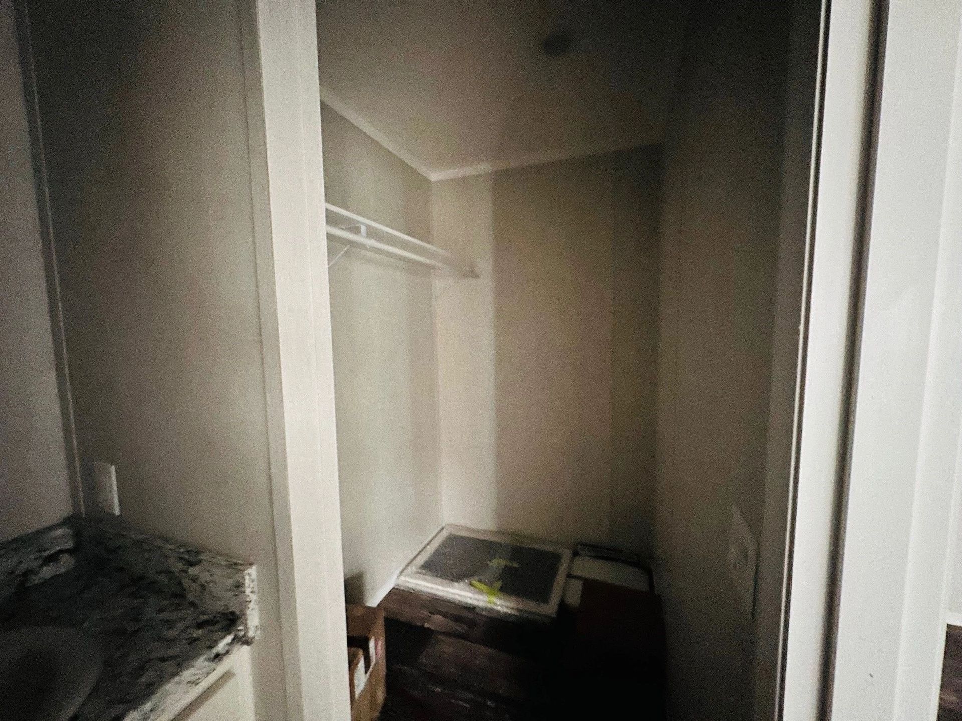 A closet with a washing machine and a sink in it.