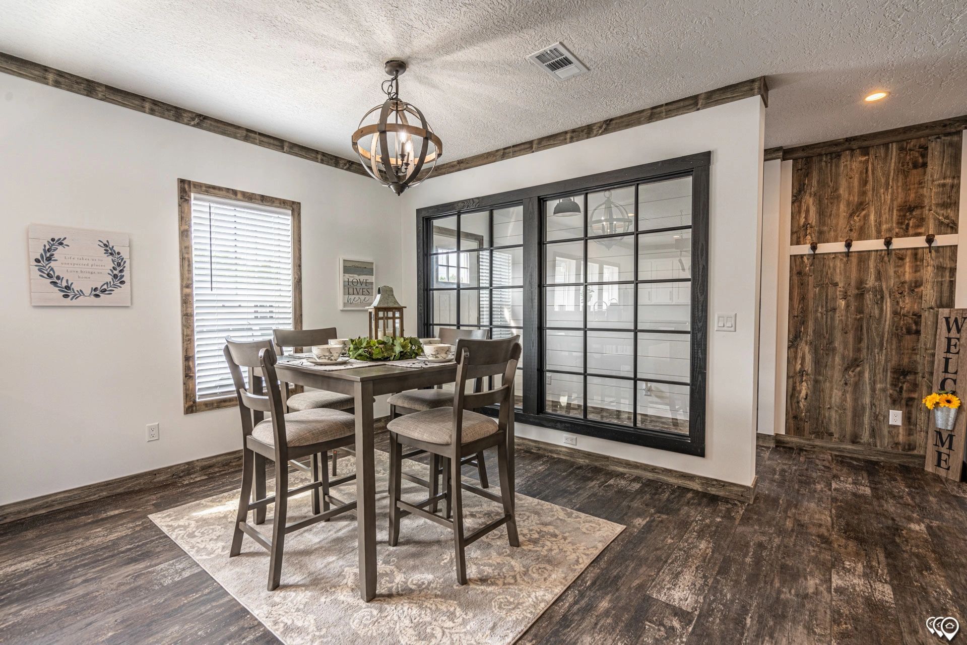 A dining room with a table and chairs and a chandelier.
