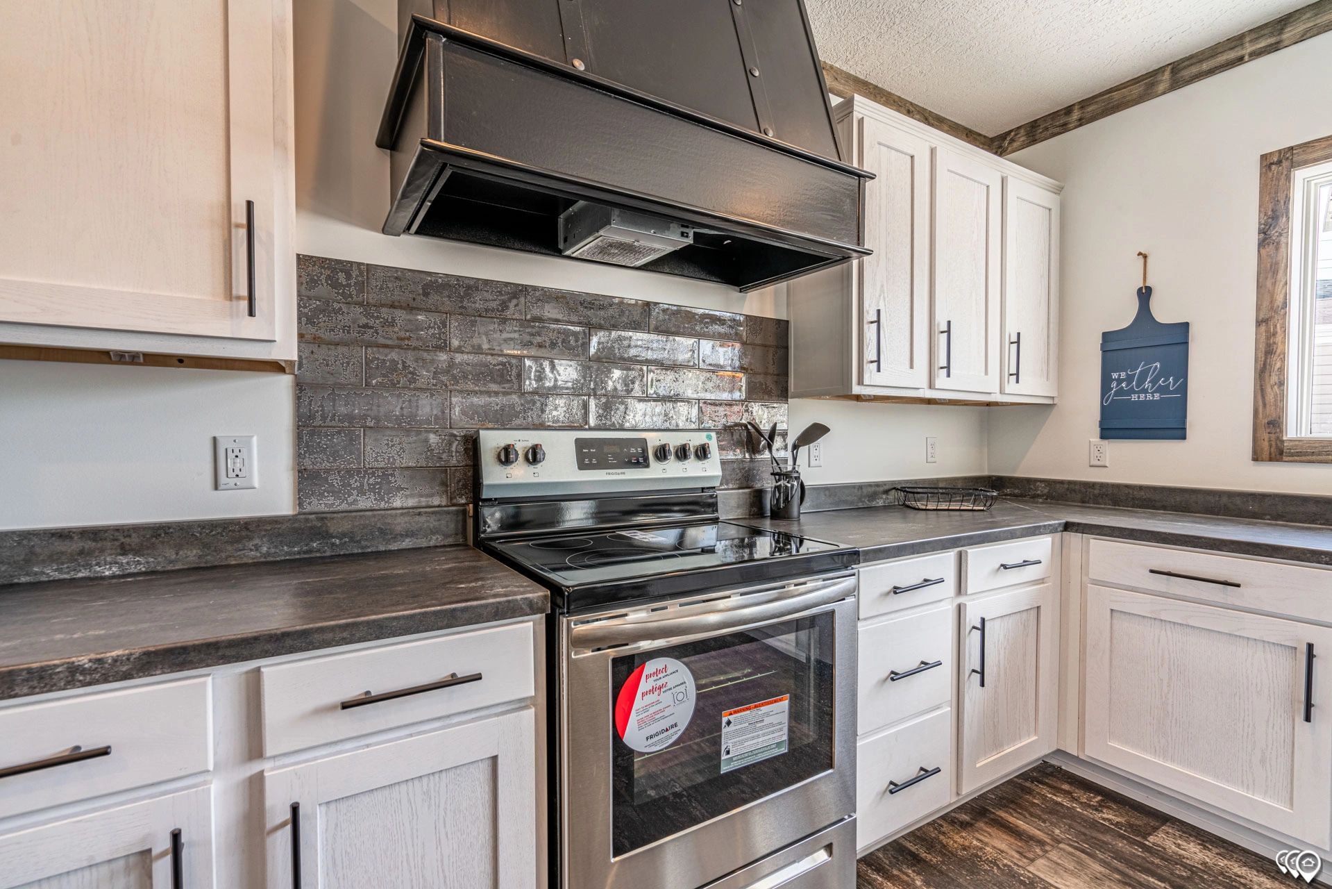 A kitchen with stainless steel appliances and white cabinets.