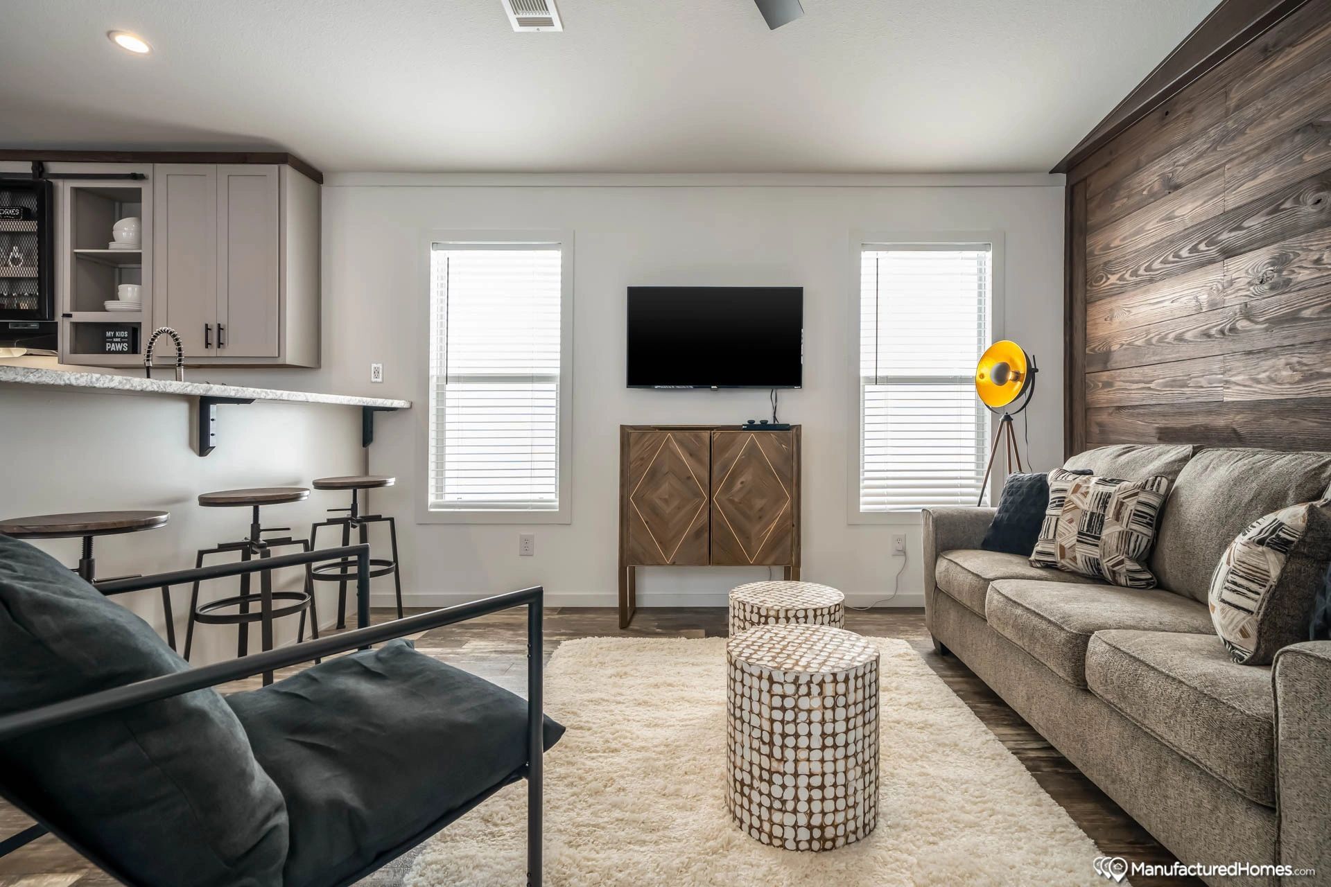 A living room with a couch , chair , table and television.
