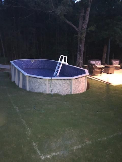 A swimming pool with a ladder in the middle of it