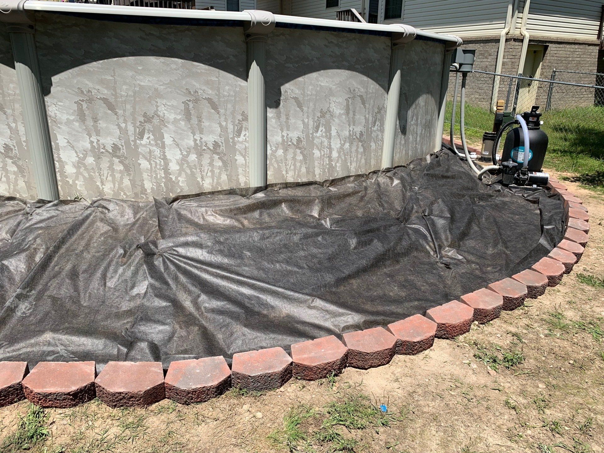 A swimming pool is being built in a backyard.