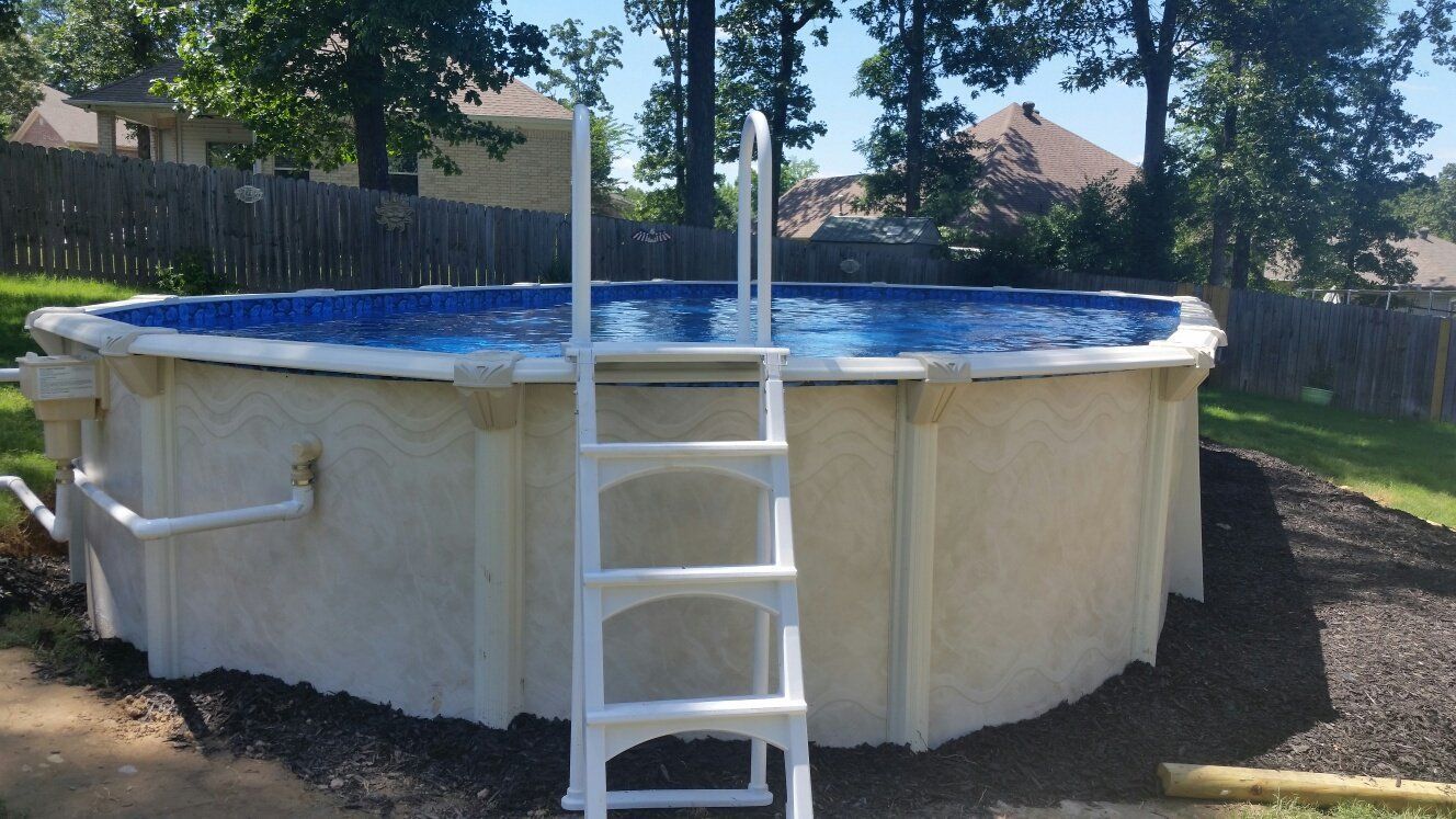 A swimming pool with a ladder attached to it