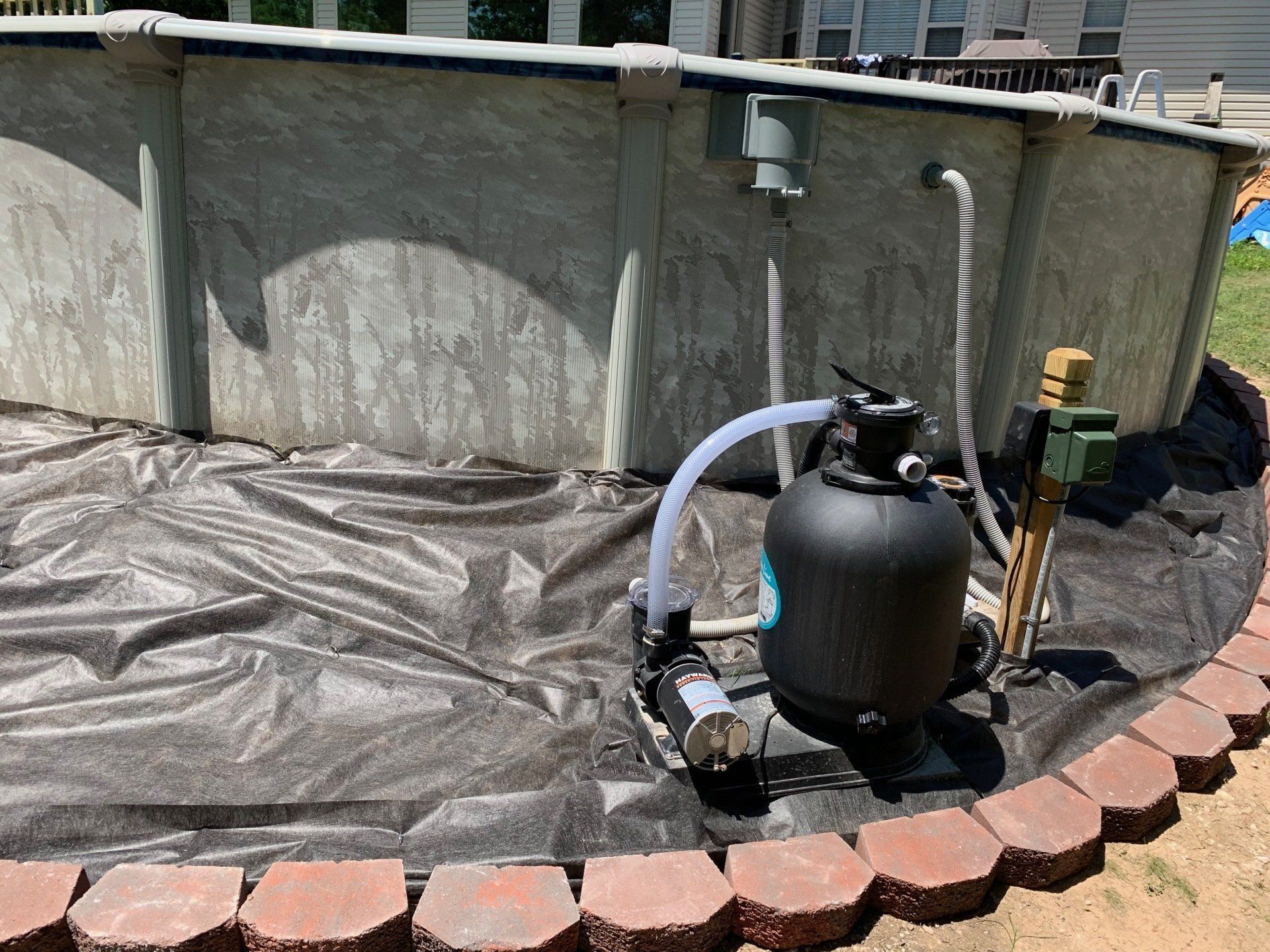 A swimming pool with a sand filter attached to it.