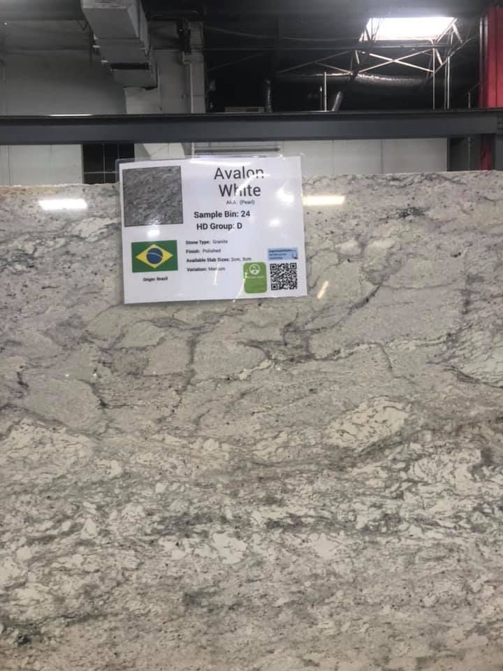Marble counter with a small awareness sign and QR code in an indoor space.