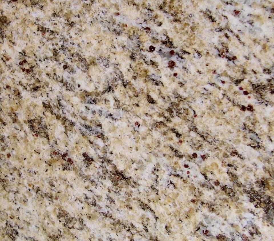 Close-up of speckled beige, cream, and brown granite texture