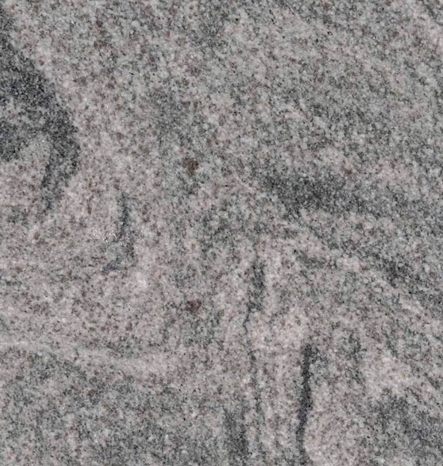 Gray speckled stone surface with a faint engraved figure and dark vertical lines